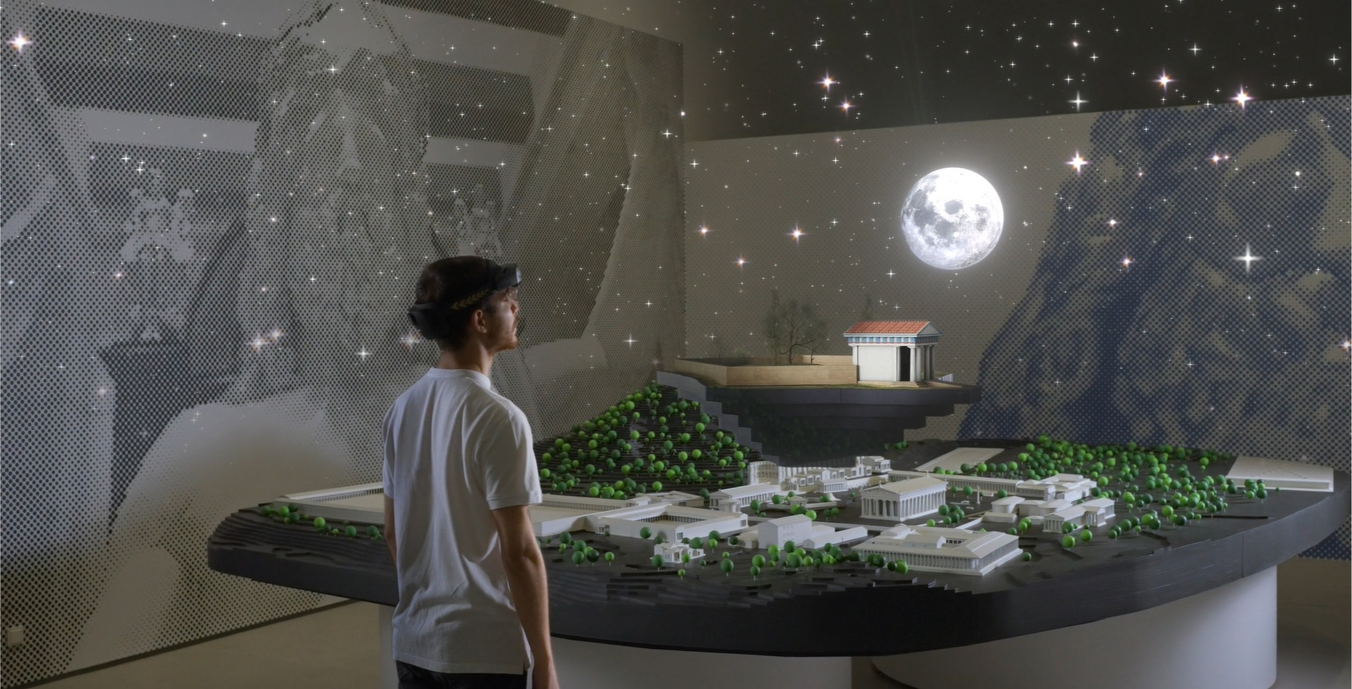 A man that wears a VR headset is enjoying a mixed reality of Ancient Olympia